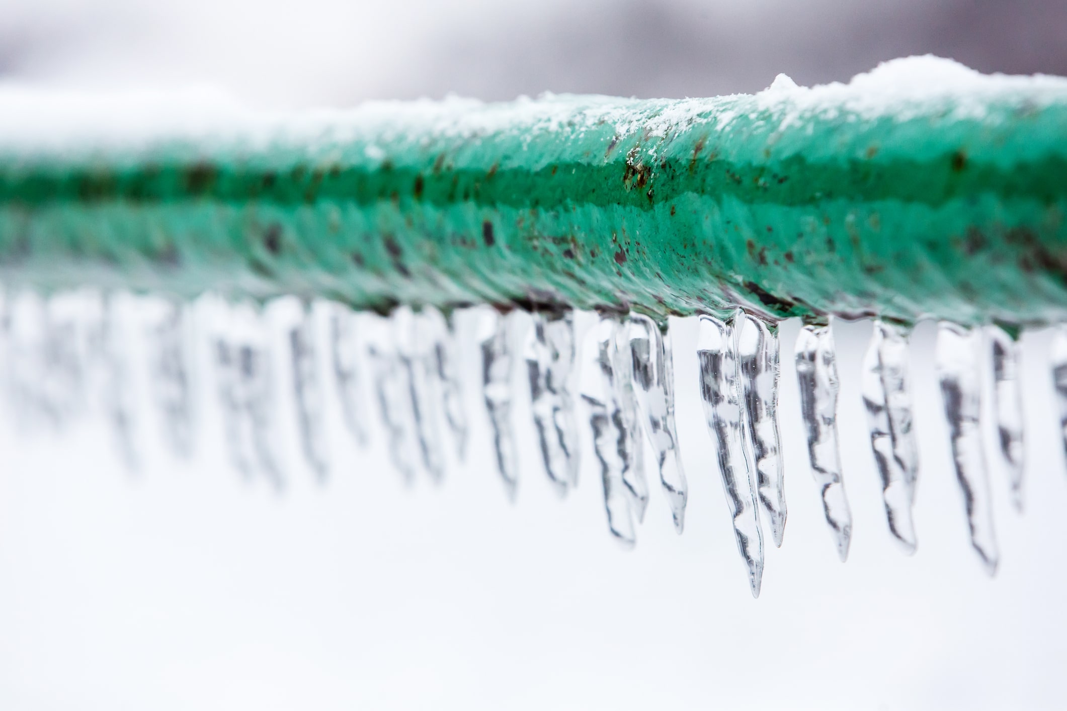 Close-up of a frozen pipe in Nashville, TN, showing ice buildup and cold-weather damage risk